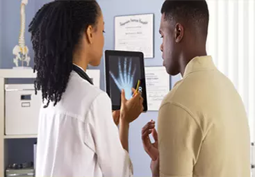 An orthopedic specialist interpreting an x-ray image
