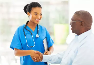 A healthcare worker smiling to a patient